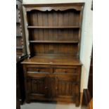 A good quality oak reproduction Welsh Dresser, with double cupboard and double drawers with linen