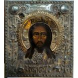 A early to mid 20th century Polish painted icon with white metal surround featuring Jesus Christ