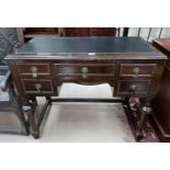 A mid 20th Century Lowboy/desk with inset leather top; an oak corner TV cupboard with leaded glass