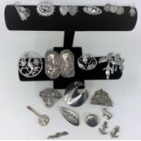 A selection of silver, continental and white metal brooches, buckles etc