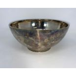 A hallmarked silver plain circular fruit bowl on raised floral embossed foot, Birmingham 1936,