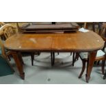 An Edwardian inlaid mahogany wind out dining table, 'D' end with 2 spare leaves, on square