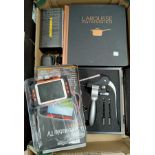 A presentation corkscrew set, boxed; a Larousse cookbook; a 3.5" portable TV; a camera; etc.