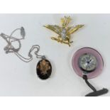 A smoky quartz pendant in silver mount and chain; a medical watch; a bird on a branch brooch