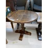 A distressed oak pedestal occasional