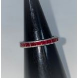 A white metal eternity ring set rectangular cut rubies, 4.1 gm