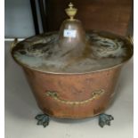 A planished copper and brass oval coal bucket with tin liner and swan feet