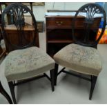 An Adam style pair of carved mahogany salon chairs with oval backs and tapestry seats