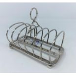 A hallmarked silver 6 division toast rack on ball feet, London 1910, 5.25 oz