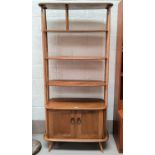An Ercol light oak wall unit\room divider of 3 shelves with double cupboard under
