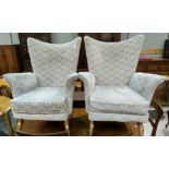 A pair of early 1950's Parker Knoll armchairs (later upholstery)