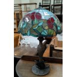 A Tiffany style bronzed table lamp with leaded coloured glass shade