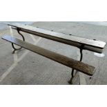 A Victorian cast iron and wood 5 - seater convertible school desk / bench with hinged top and