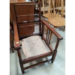 A 1930's oak adjustable armchair with low seat
