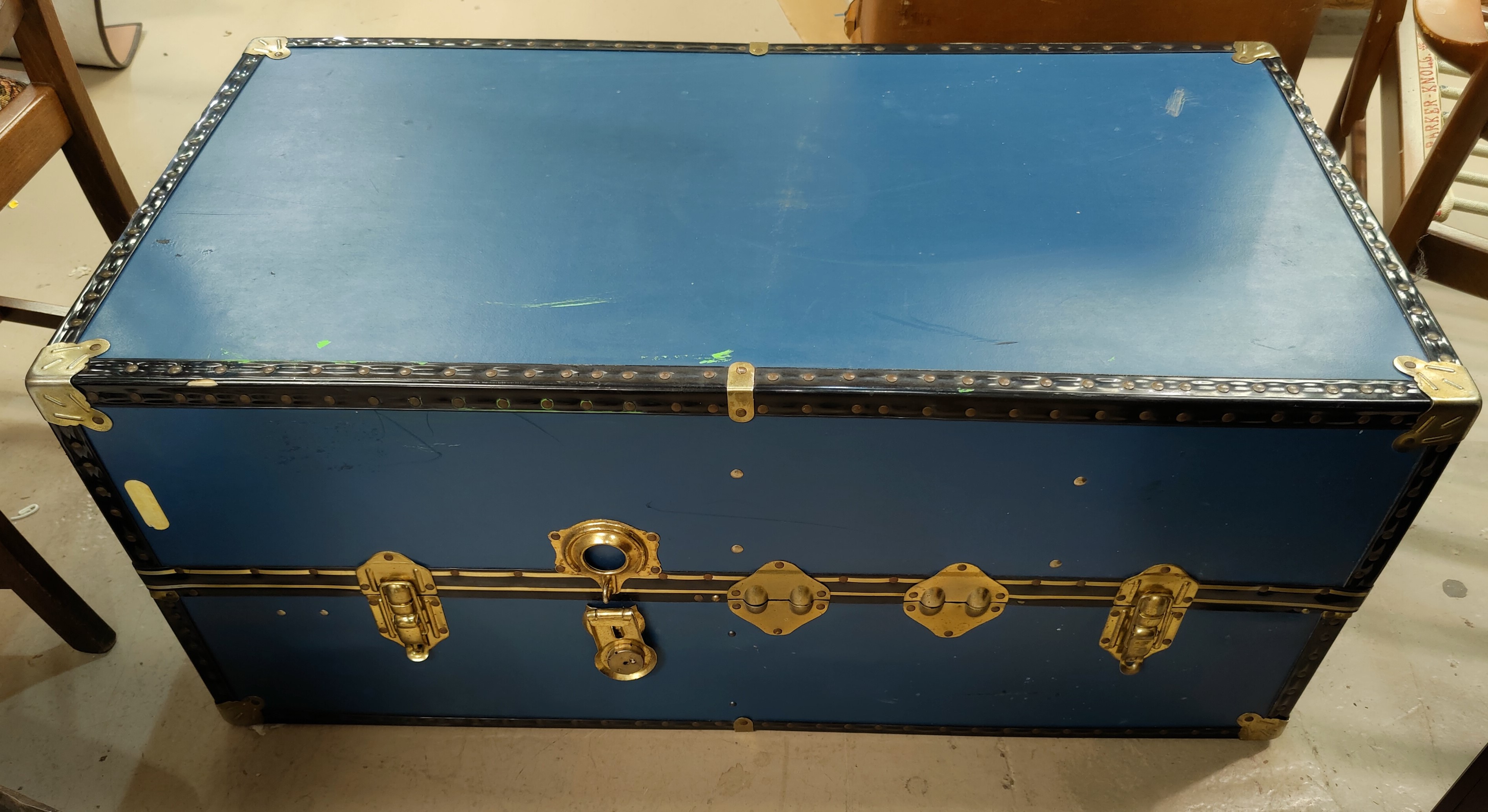 A large blue metal bound cabin trunk