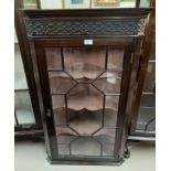 A mahogany single door wall hanging corner cupboard.