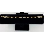 A 9 carat gold hallmarked bracelet, central word 'MUM' set with clear stones 8.5gm