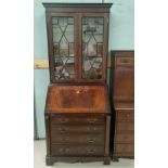 A small reproduction bureau/bookcase in crossbanded mahogany