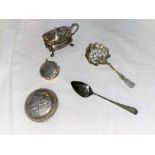 A continental white metal box with embossed landscape; a hallmarked silver sifter spoon; a