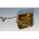 A yellow metal brooch set large cushion cut rectangular topaz, scrollwork frame, unmarked, 11 gm