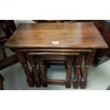 An old charm nest of three oak occasional tables on turned legs.