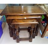 An oak occasional table with oval drop leaf top, on barley twist legs; a nest of 3 oak