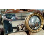 A circular gilt framed convex mirror, another brass framed mirror
