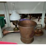 A large copper coal bucket with elongated handle. Copper horn; brass jam pans; an oil lamp etc.