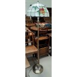 A Tiffany style brass standard lamp with leaded coloured glass shade