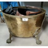A large brass coal bin on paw feet; a smaller scuttle