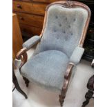 A Victorian mahogany scroll armchair with curved legs
