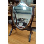 A free standing dress table mirror in shield shaped frame