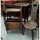 An oak magazine rack/bookshelf; a spinning chair; a 1930's low seat armchair