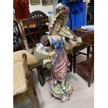 A large majolica figure of a girl in bonnet, height 100cm