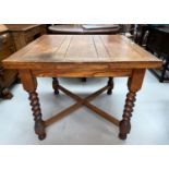 An oak drawer leaf dining table with barley twist legs x stretcher.