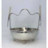 A hallmarked silver nut bowl on ball feet with twin picks and 2 pairs of nutcrackers, Sheffield 1925