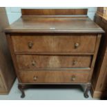 A burr walnut chest of three long drawers with bakelite handles and cabriole legs