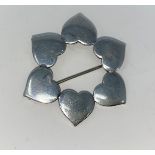 A Danish silver brooch in the form of a circle of hearts. Marked on back: Danish Silver & makers