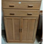 A limed Oak tall boy with two drawers and double cupboard below