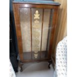 A 1920's mahogany single door display cabinet with single door and double shelves.