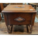 An oak sewing box with beaded decoration, on bobbin legs
