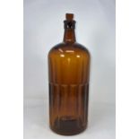 A vintage ribbed brown glass bottle marked 'POISON' in relief, with glass stopper, height 37cm