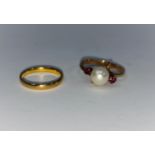 A 22 carat hallmarked gold wedding ring, 2.5 gm; a pearl and ruby set ring, stamped '14k'