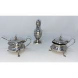 A hallmarked silver pair of mustard pots, Birmingham 1942; a silver pepper pot with fluted