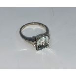 A white metal dress ring set clear / pale blue cushion cut rectangular stone, stamped '14K', 2.8 gm