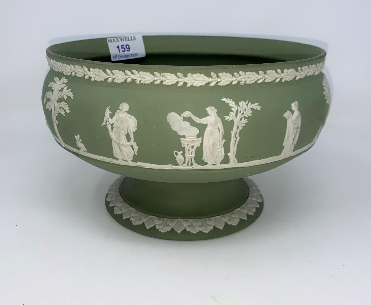 A Wedgewood Jasperware green pedestal bowl decorated with classical scenes.