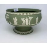 A Wedgewood Jasperware green pedestal bowl decorated with classical scenes.