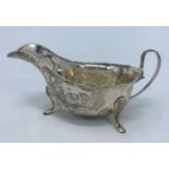 A hallmarked silver sauce boat with cut rim, on 3 feet, Sheffield 1938, 3.5 oz