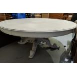 A Victorian style very large dining table in light grey 'shabby chic' finish, circular top with