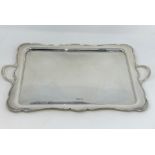 A scalloped rectangular silver tray with 2 handles, Sheffield 1925, 48 oz